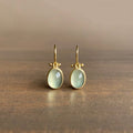 Elegant vintage earrings with radiant green moonstone