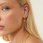 Gold Crystal Moon Charm Huggies styled on ear