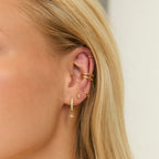 Gold Crystal Star Charm Huggies styled on ear
