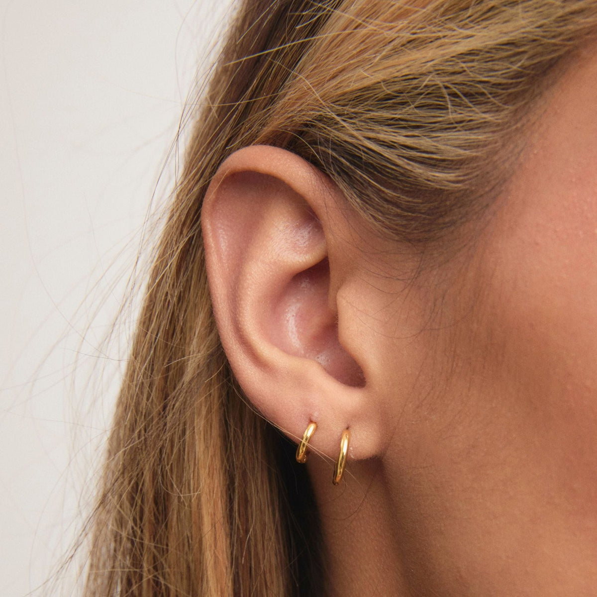 Women Small Huggie Hoop Earrings With Clicker Closure in gold tone