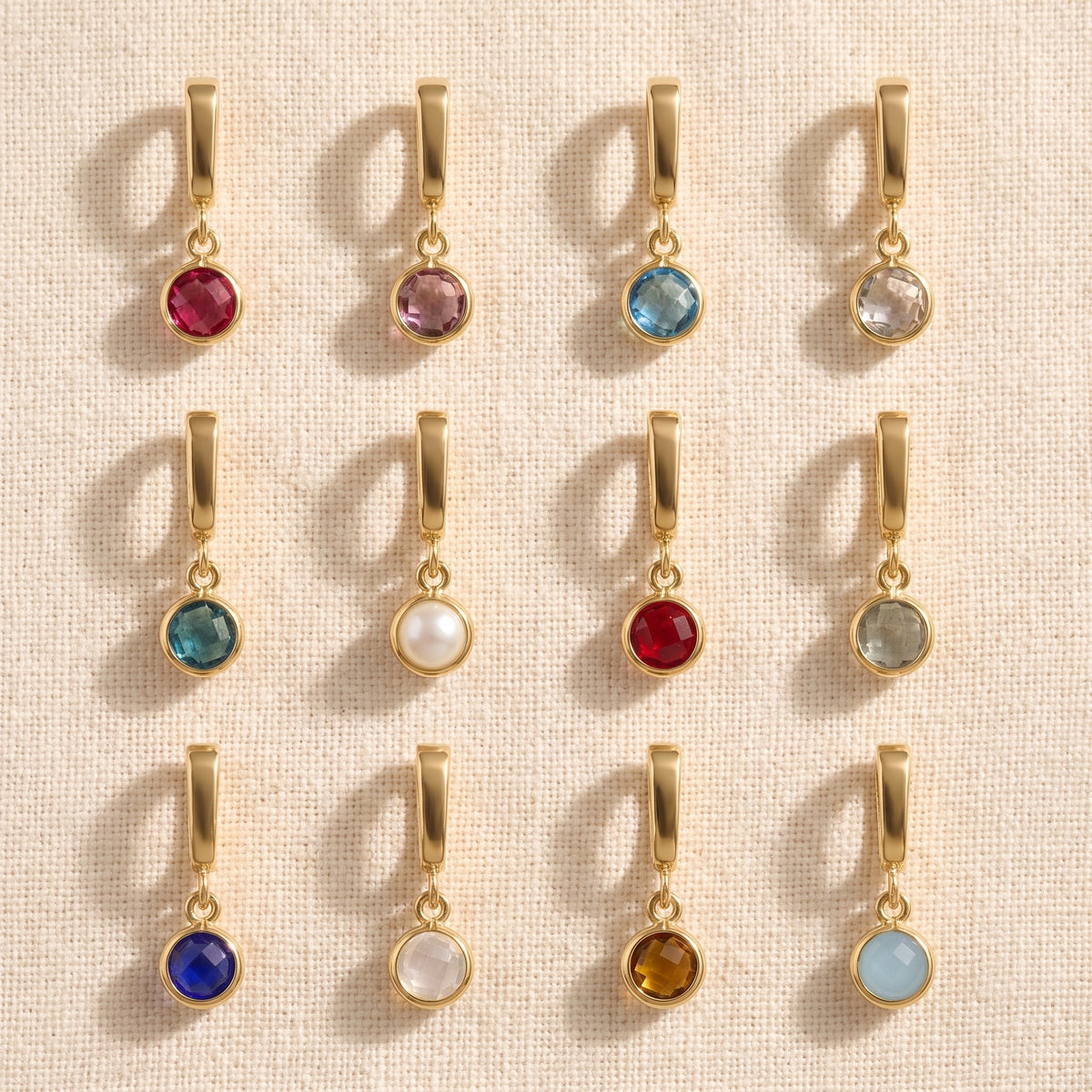 Bezel Birthstone Charms, twelve birthstone charms flat lay