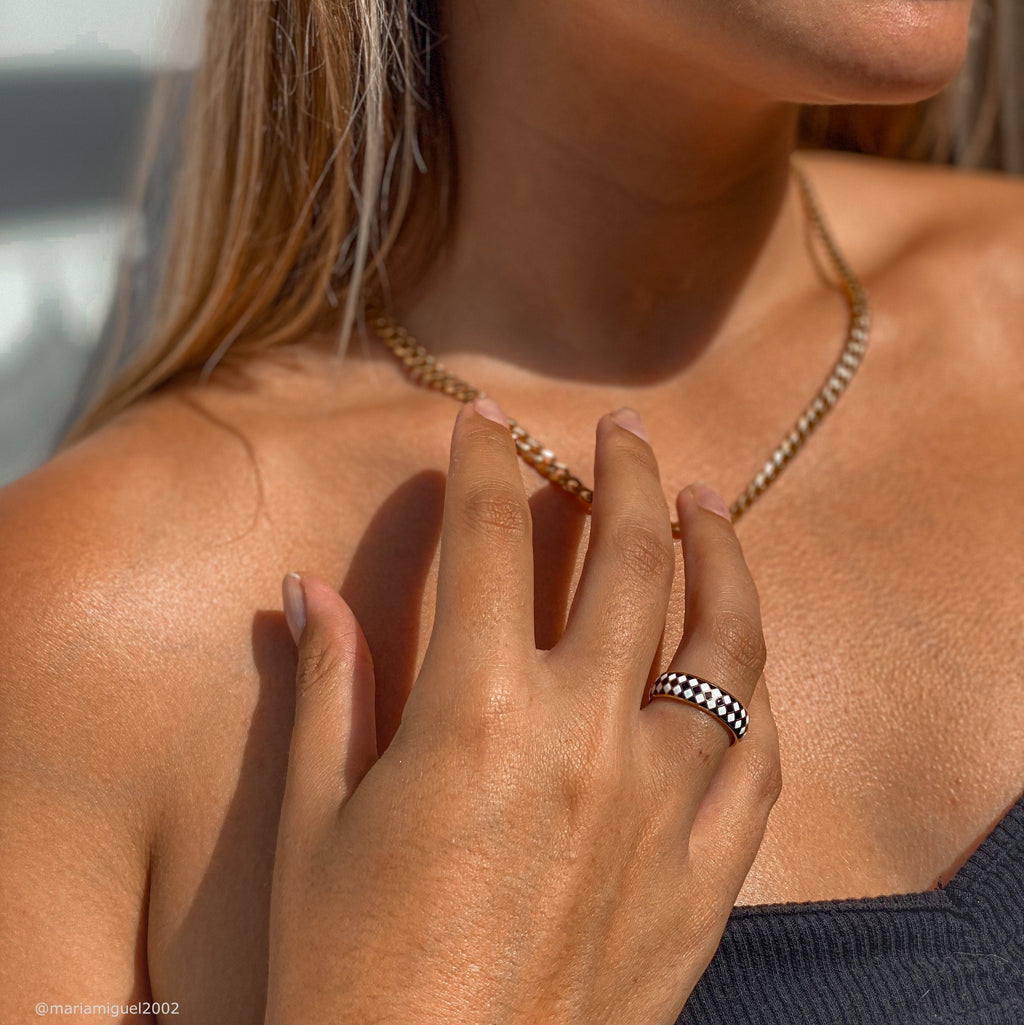 woman wearing a black and white check band ring