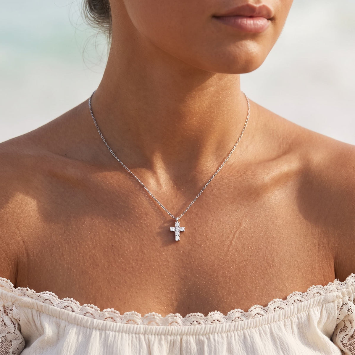 Wider view of a woman wearing the Crystal Cross Pendant