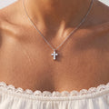 Close-up of the Crystal Cross Pendant worn on the neckline