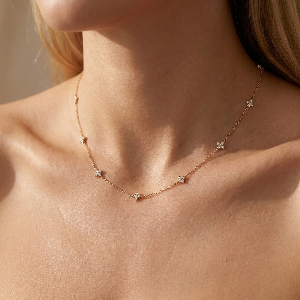 Woman wearing the Mia dainty gold necklace with small crystal clusters spaced along the chain
