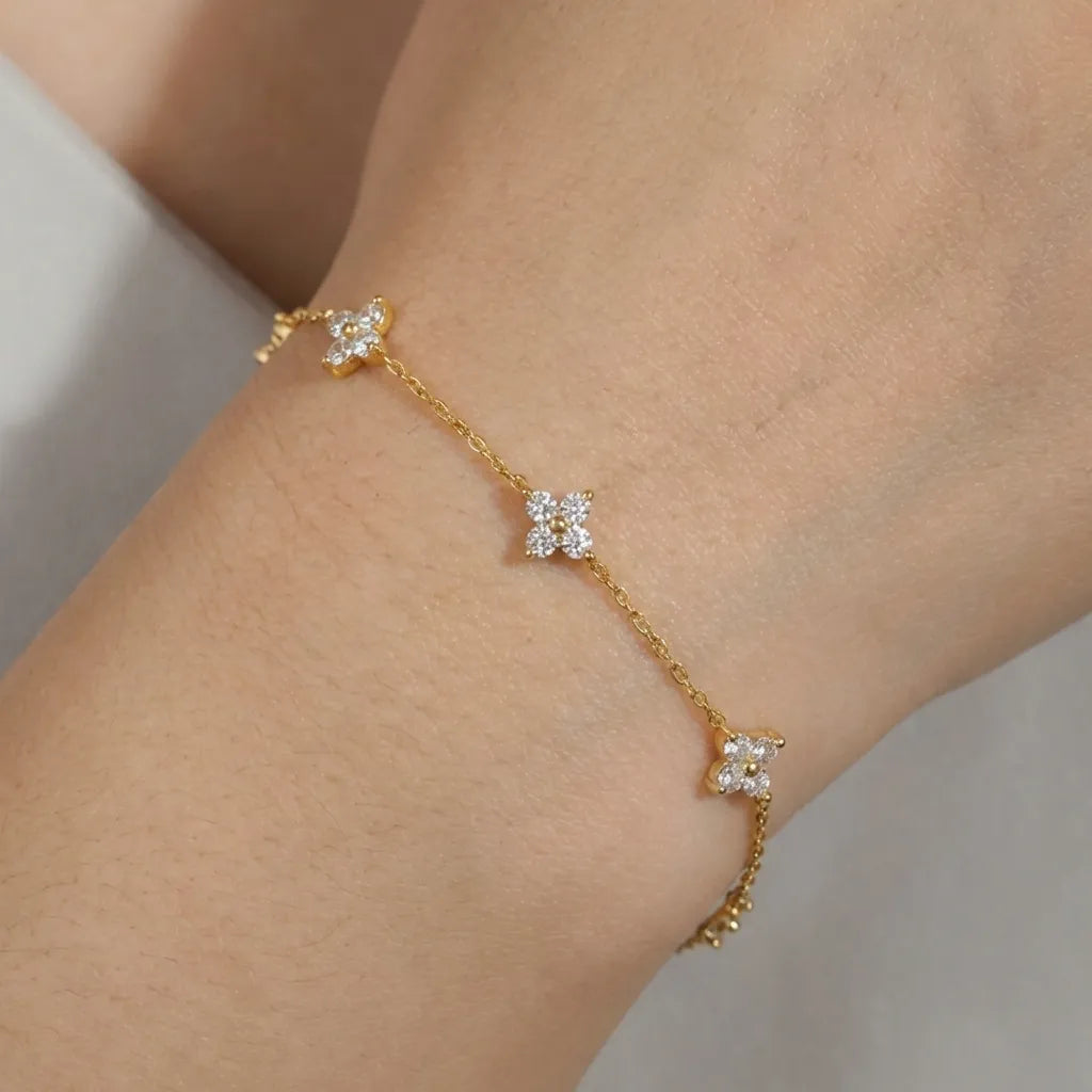 Mia dainty gold bracelet with zircon crystal flower stations worn on the wrist