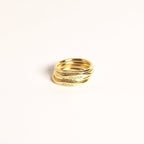 Four stacked Ann Skinny Name Rings in Rose Gold, engraved with Maria, Quinn, Greta, and Anna, shine on a plain white background—making a thoughtful Christmas gift for her.
