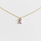 The Celia Necklace by LLUME Jewelry is a delicate gold vermeil piece featuring a small rectangular lilac gemstone pendant, elegantly showcased on a plain white background.