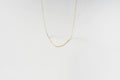 The Adelene Paperclip Chain by LLUME Jewelry features delicate gold-plated oval links, elegantly displayed against a plain white background.