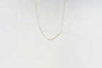 The Adelene Paperclip Chain by LLUME Jewelry features delicate gold-plated oval links, elegantly displayed against a plain white background.