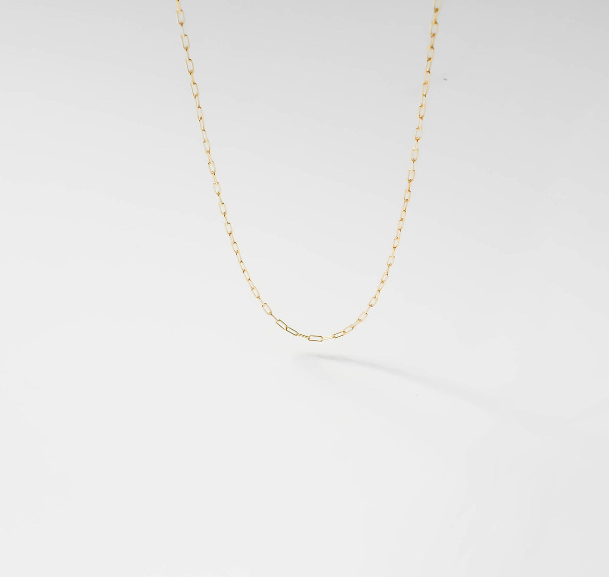 The Build a Birthstone Necklace by LLUME Jewelry features a delicate gold chain with small oval links against a white background, offering a minimal, elegant look—ideal for layering or creating your own custom charm necklace.
